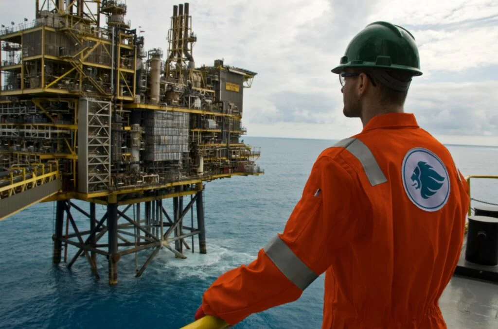 Expro eyeing market growth after broadening drilling tech offering with acquisition of Norwegian firm Man looking at an offshore platform