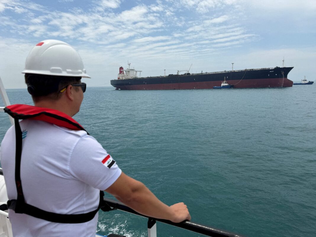 The Race To Rescue 8,000 Sailors Still Stranded Behind Hormuz A sailor observes the oil tanker HELGA